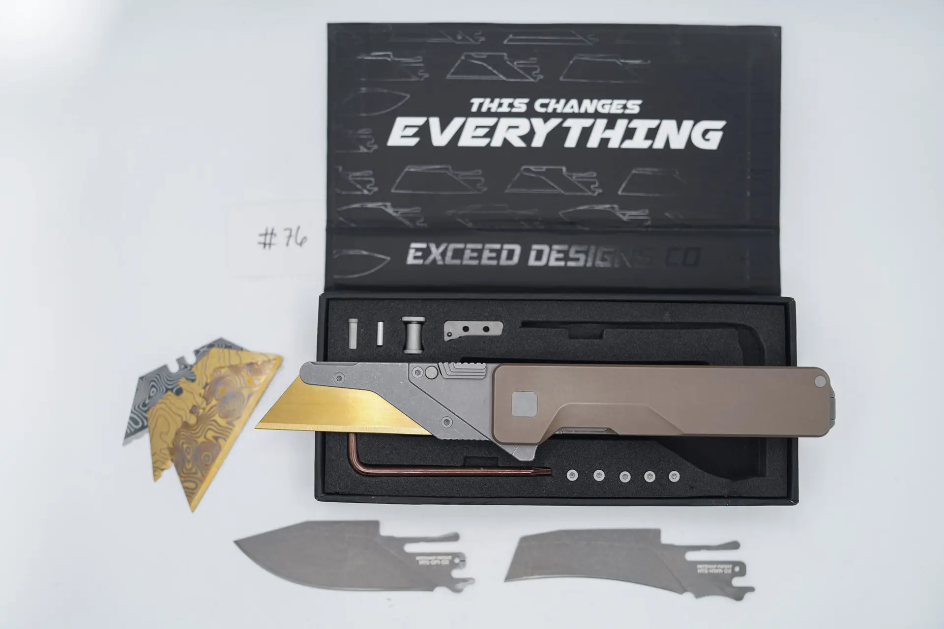 BUILD #76 — Condition 9/10 — TiRant ULTRA SMOOTH Centurion Bronze – Minor Blem in ANO finish (See Photos) W/Blasted Grey Hardware + Original Box W/Spare Grey Blasted Hardware Kit / Lock Bar insert + D2 Stonewashed Hawkbill Hotswap Blade + D2 Stonewashed Drop Point Hotswap Blade + 3X Custom Laser Engraved Razor Blades