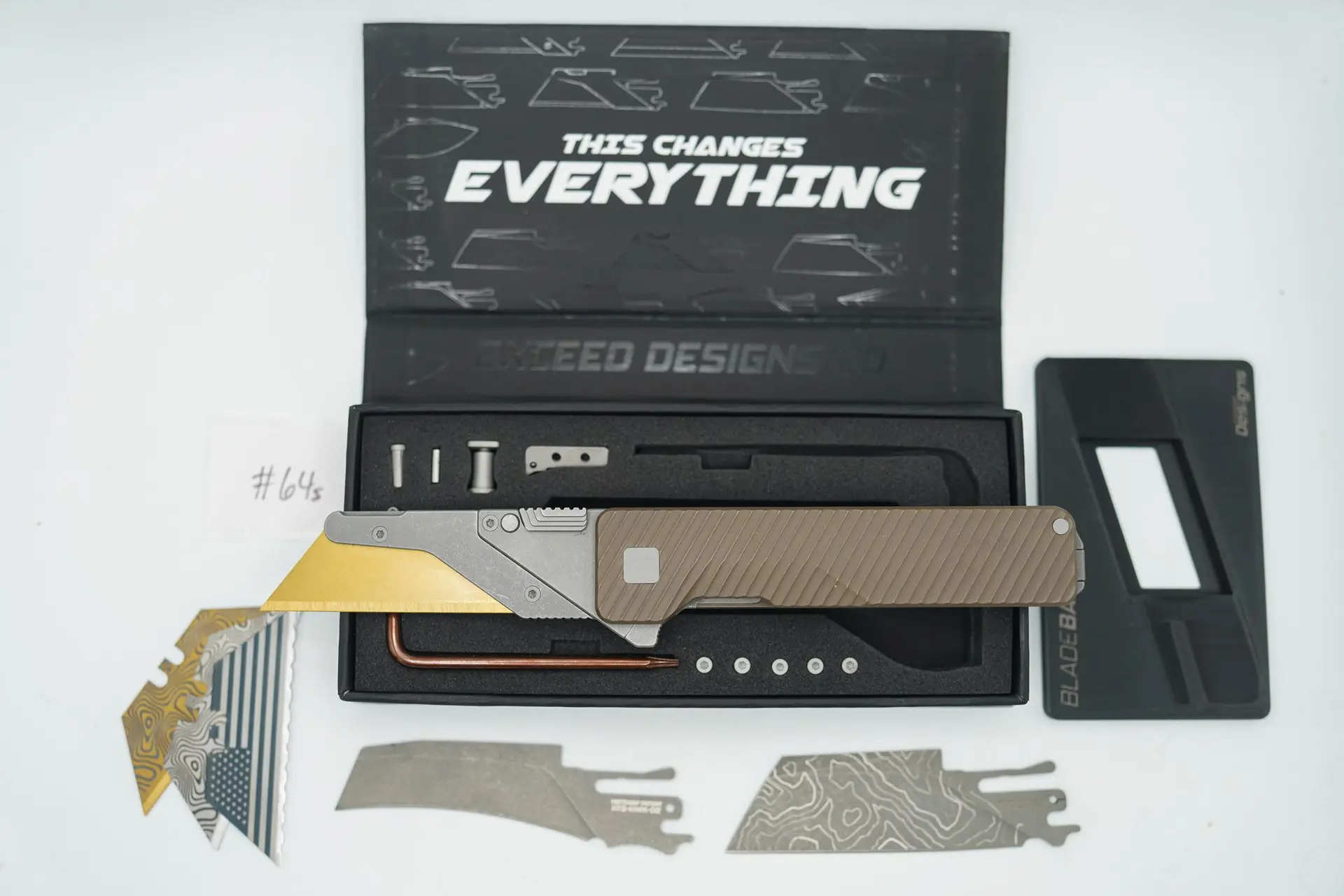 BUILD #64s — Condition 9/10 — TiRant ULTRA Dual Milled SLASH W/Centurion Bronze ANO + SKIFF Bearings Pre-Installed + Installed Skeleton Stonewash Full Flush Backspacer + Original Box W/ Spare Blasted Grey Hardware Kit / Lock Bar insert + D2 Stonewashed Hawkbill Hotswap Blade + D2 Stonewashed V2-Topo Laser Engraved Hotswap Sheepsfoot Blade + 3X Custom Laser Engraved Razor Blades + Blem HotSwap BladeBank