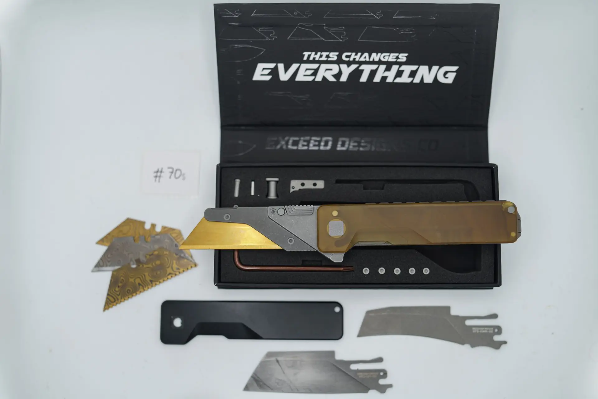 BUILD #70S — Condition 7/10 — TiRant ULTRA Deep Slash Stonewash LH Scale + Blem/Crack Ultem RH Scale (See Photo) + SKIFF Bearings Installed + Black Titanium Smooth RH Scale + Original Box W/Spare Jet-Black PVD Hardware Kit / Lock Bar insert + D2 Stonewashed Hawkbill Hotswap Blade + BLEM (See photos) D2 Stonewashed Sheepsfoot Hotswap Blade + 3X Custom Laser Engraved Razor Blades