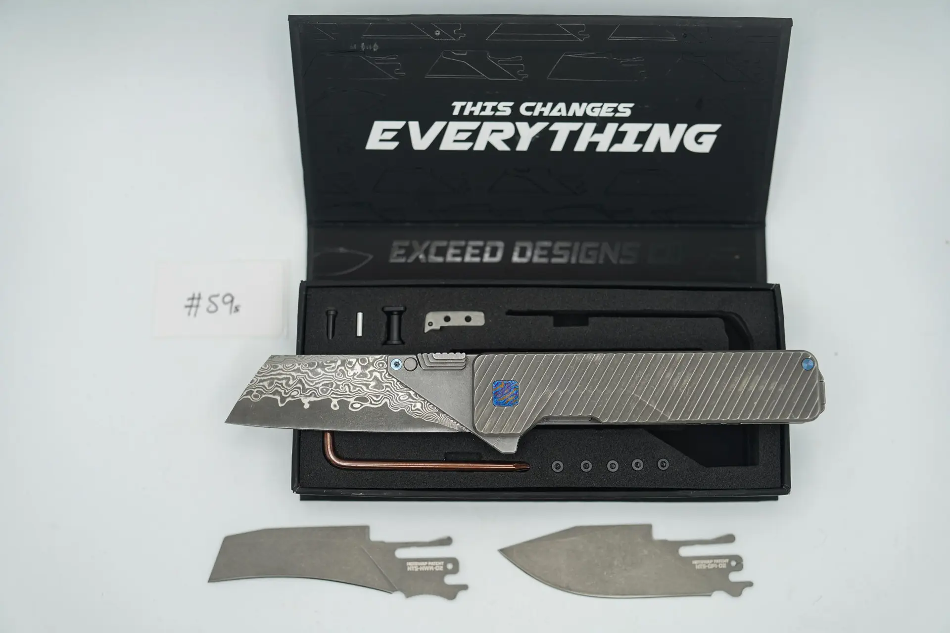 BUILD #59s — Condition 8/10 — TiRant ULTRA – Dual DEEP SLASH Milled Scales + Blem-Corners TiMascus Pivot Set + Installed Blue ANO Screw Set + Original Box W/Jet-Black Hardware Kit + Installed Skiff Bearings + D2 Stonewashed Drop Point Hotswap Blade + D2 Stonewashed Hawk Bill Hotswap Blade