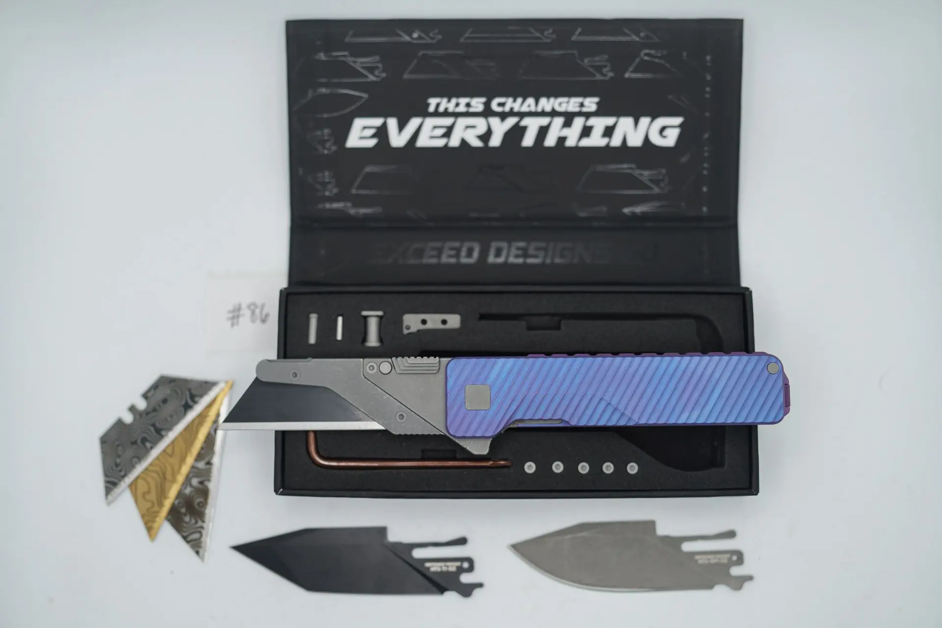 BUILD #86 — Condition 9/10 — TiRant ULTRA Dual Deep Slash MILLED + Purple & Blue ANO W/Blasted Grey Hardware + Original Box W/Spare Grey Blasted Hardware Kit / Lock Bar insert + FULL-FRAG Custom Purple-Haze ANO Ti Backspacer + D2 Jet-Black Tanto Hotswap Blade + D2 Stonewashed Drop Point Hotswap Blade + 3X Custom Laser Engraved Razor Blades