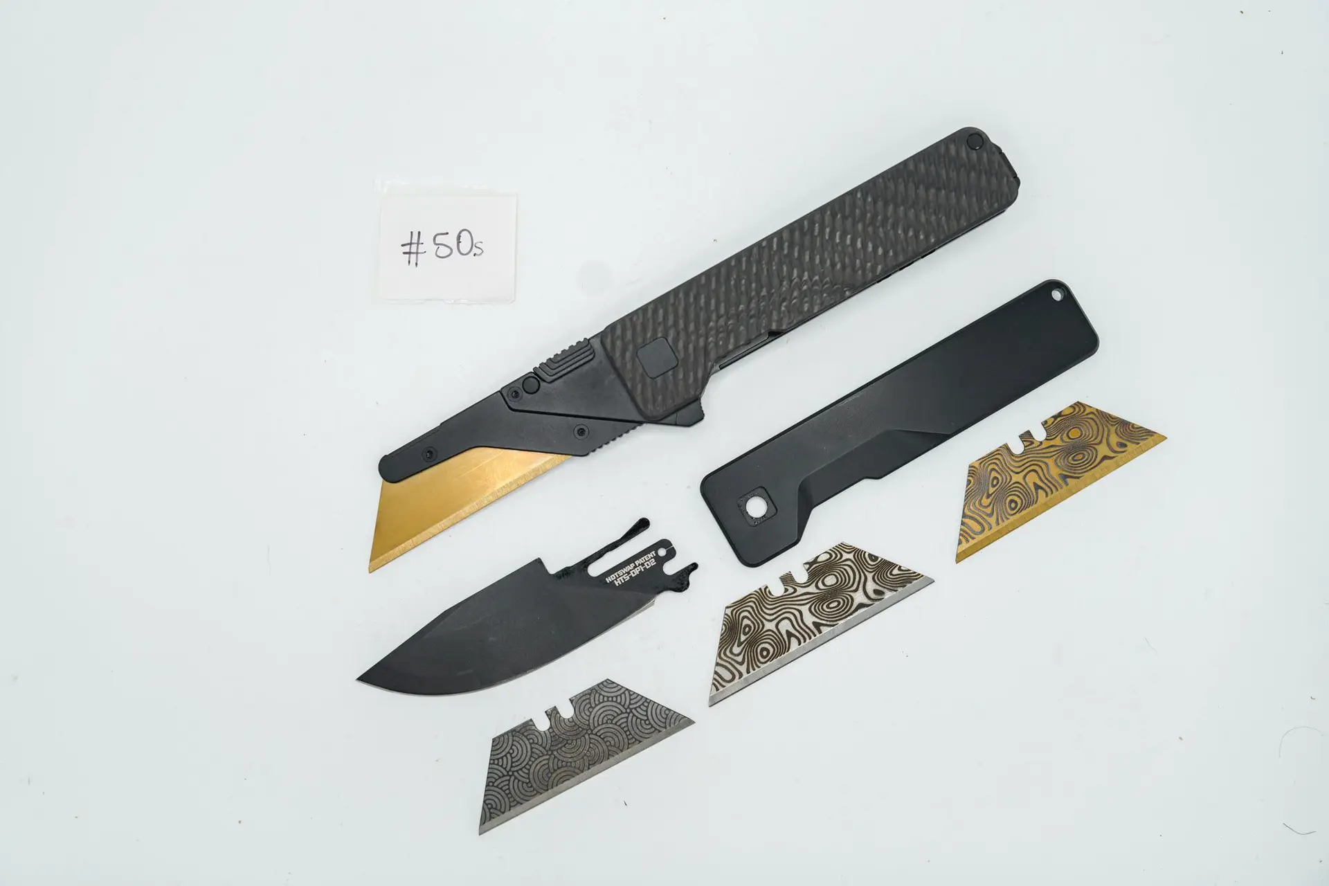 BUILD #50s Combo — Condition 9/10 — TiRant ULTRA Carbon Fiber USA-Milled Deep Slash RH Scale + Jet-Black PVD Smooth LH Scale + Original Deep Smooth RH Ti Black PVD Scale + Installed SKIFF Bearings + 3X Custom Laser Engraved Razor Blades + Blem D2 Drop Point Style Hotswap Blade