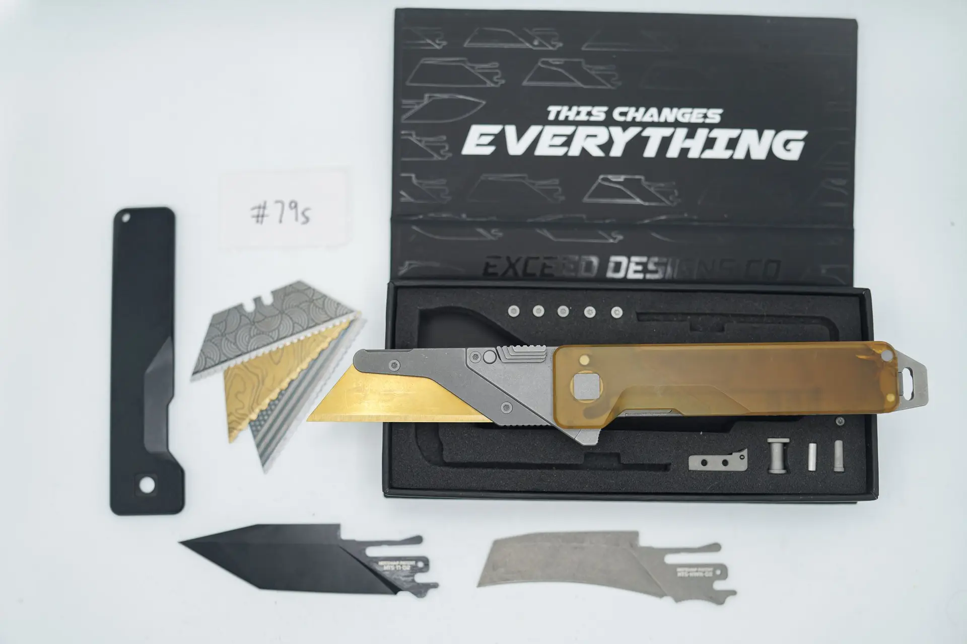 BUILD #79s — Condition 7/10 — TiRant ULTRA Deep Slash Stonewash LH Scale + Blem/Crack Ultem RH Scale (See Photo) + SKIFF Bearings Installed + Spare Black Titanium Smooth RH Scale + Original Box W/Spare Grey Blasted Hardware Kit / Lock Bar insert + Skeleton Pry bar Rear Full back Spacer + D2 Stonewashed Hawkbill Hotswap Blade + D2 Jet-Black Tanto Hotswap Blade + 3X Custom Laser Engraved Razor Blades