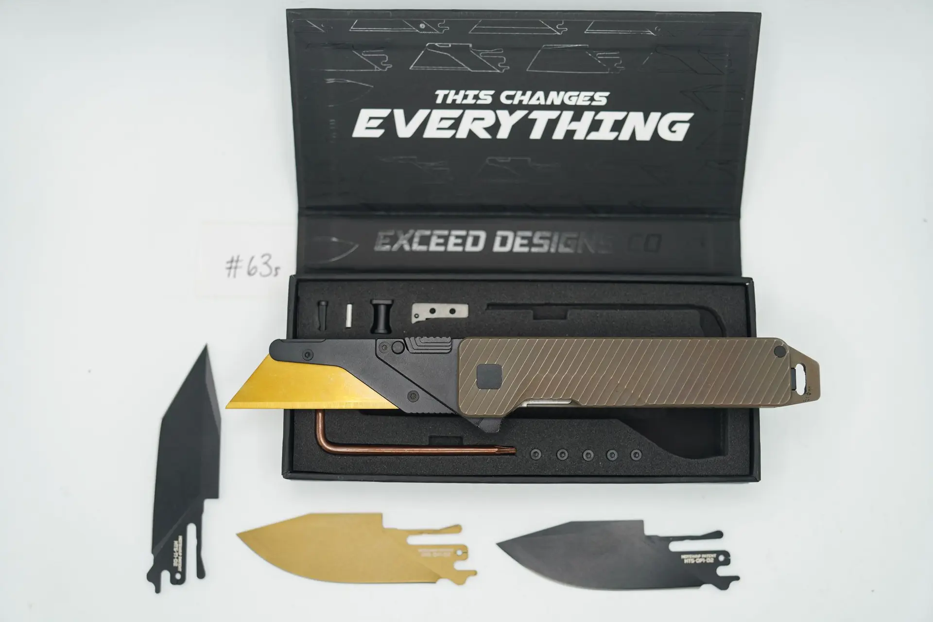 BUILD #63s — Condition 9/10 — TiRant ULTRA Dual Milled SLASH W/Centurion Bronze ANO + Pre-Installed SKIFF Bearings + Original Box W/ Spare Jet-Black Hardware Kit / Lock Bar insert + FULL Skeleton Pry Bar Full Backspacer + D2 Jet-Black Drop Point Hotswap Blade + D2 Jet-Black Tanto Hotswap Blade + D2 TiN Coated (Gold Colored) Drop Point Hotswap Blade