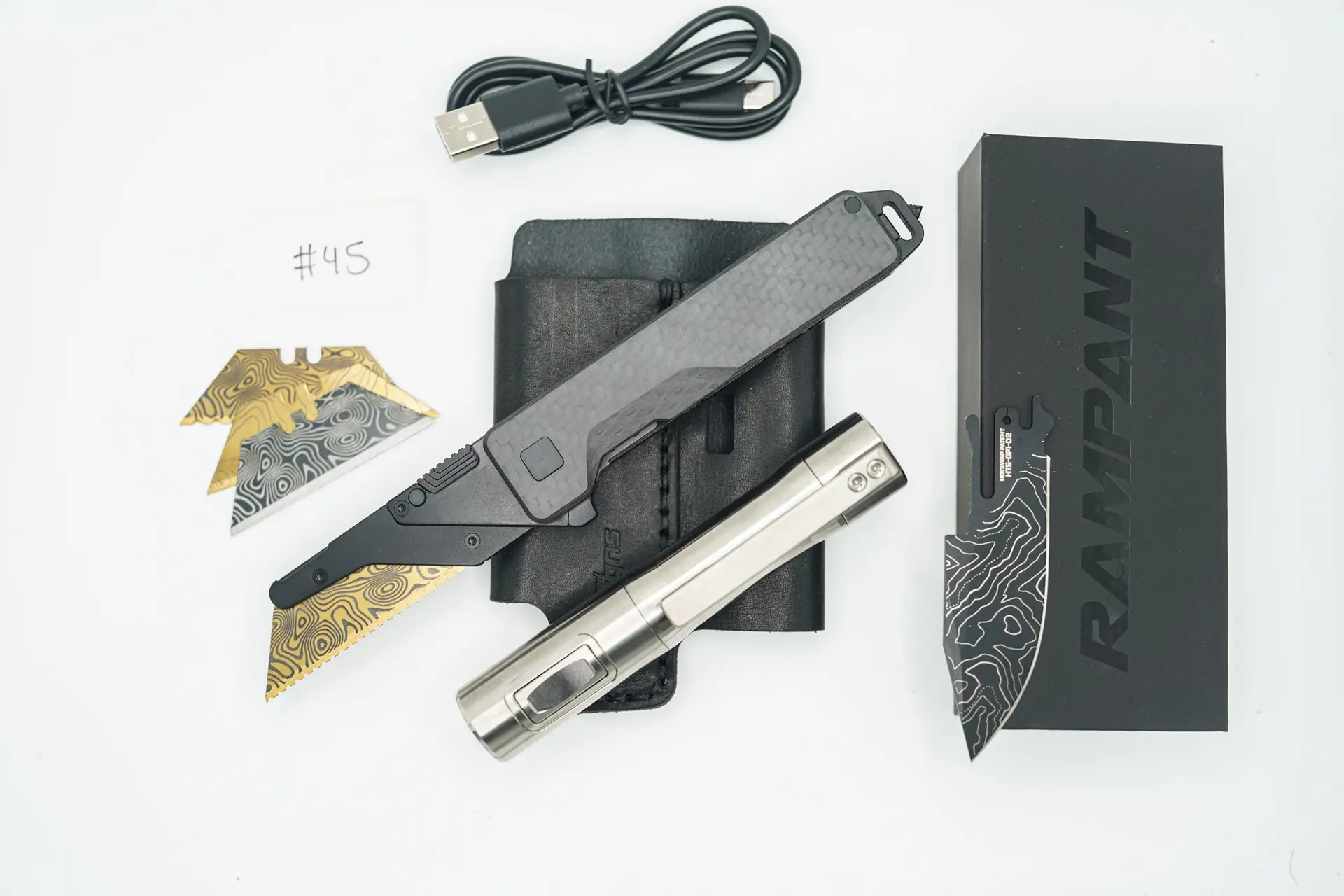 BUILD #45 Combo — Condition 9/10 — TiRant ULTRA 50/50 Carbon Fiber RH Scale / Jet-Black PVD Titanium LH Scale + Skeleton Glass Breaker Loop Backspacer + D2 Topo Half Laser Engraved Drop Point Hotswap Blade + 4X Custom Laser Engraved Razor Blades + 10/10 RAW 519a Rampant R4 Aluminum Flashlight + 10/10 Black Leather FieldPro Pocket Organizer W/Belt Loop