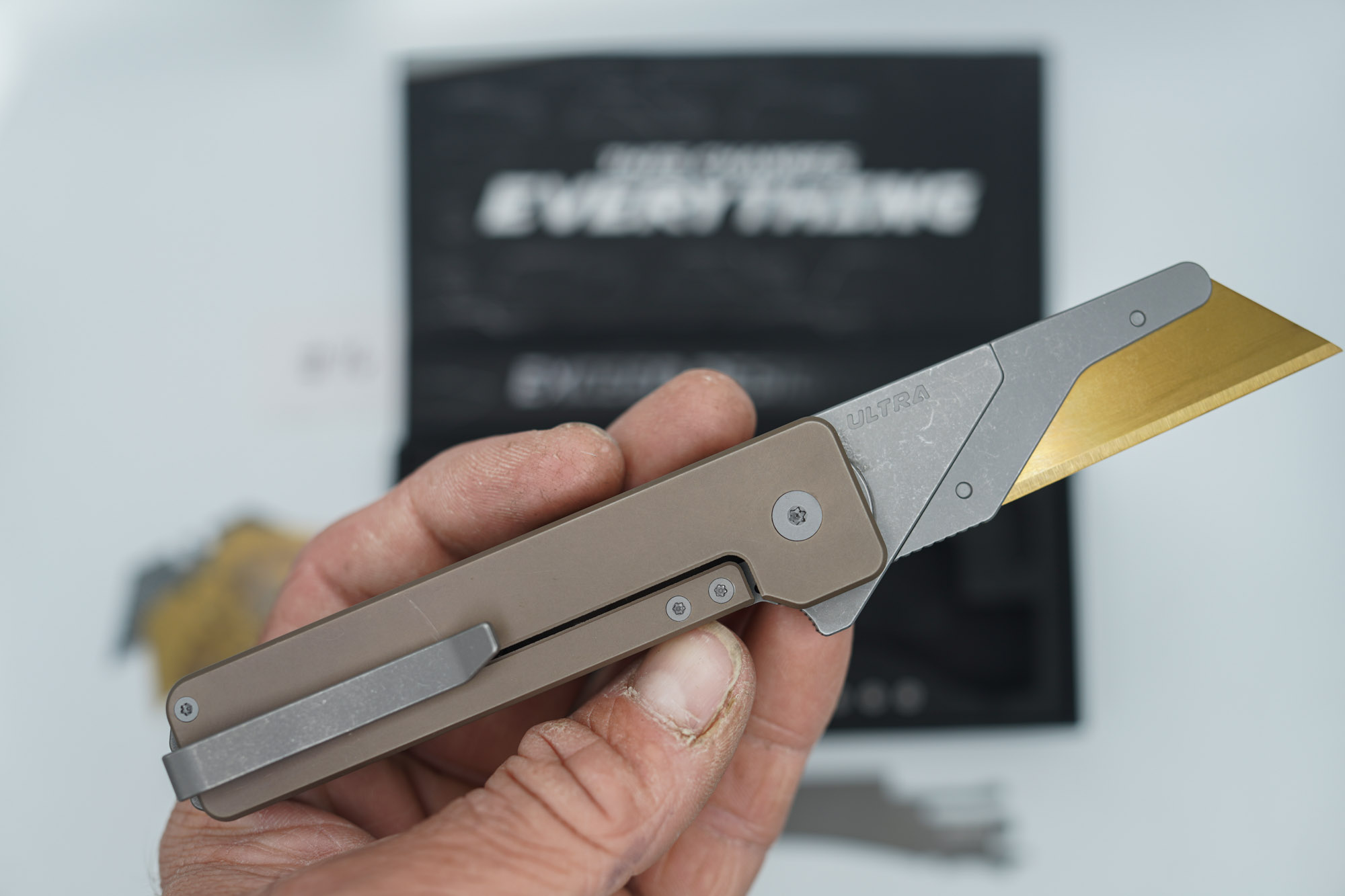 BUILD #76 — Condition 9/10 — TiRant ULTRA SMOOTH Centurion Bronze - Minor Blem in ANO finish (See Photos) W/Blasted Grey Hardware + Original Box W/Spare Grey Blasted Hardware Kit / Lock Bar insert + D2 Stonewashed Hawkbill Hotswap Blade + D2 Stonewashed Drop Point Hotswap Blade + 3X Custom Laser Engraved Razor Blades - Image 4
