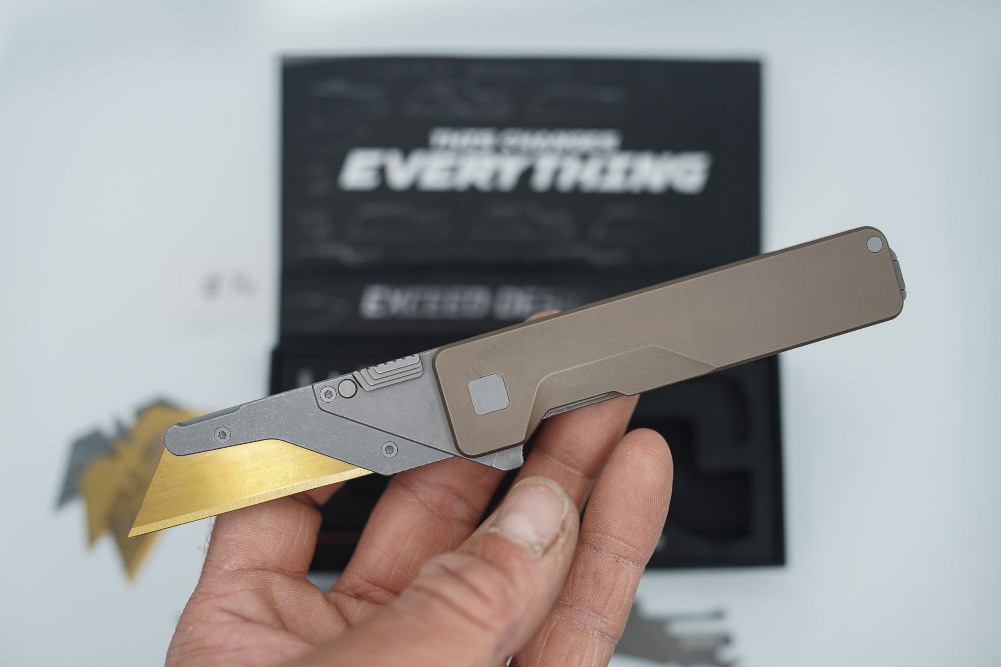 BUILD #76 — Condition 9/10 — TiRant ULTRA SMOOTH Centurion Bronze - Minor Blem in ANO finish (See Photos) W/Blasted Grey Hardware + Original Box W/Spare Grey Blasted Hardware Kit / Lock Bar insert + D2 Stonewashed Hawkbill Hotswap Blade + D2 Stonewashed Drop Point Hotswap Blade + 3X Custom Laser Engraved Razor Blades - Image 2