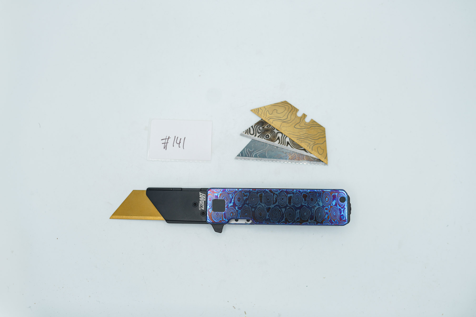 BUILD #141S — Condition 10/10 — TiRant RAZOR V3 Grade A Prime Photo Sample (Multi-Layered Forged Titanium + Torch ANO) TiMascus + Pre-Installed SKIFF Bearings + Pro Clip Installed + 3X Custom Laser Engraved Razor Blades From The ToolRoom